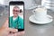 Smartphone video call to talk with your doctor drinking coffee