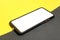 Smartphone, white screen. Mobile app mockup. Yellow and black background
