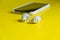 Smartphone white wireless headphones on a bright yellow background