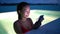 Smartphone - woman using mobile cell phone app on vacation in pool at night