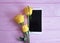 Smartphone, yellow roses romance present table on a pink wooden background