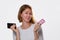 Smartphones and Bank cards. A pretty blonde woman holding a smartphone and a Bank card, on a white background. Copy