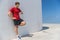 Smartwatch runner man checking progress on smart fitness sport watch during running break cardio workout training