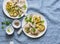 Smashed roasted sage butter potatoes and mustard cream sauce meat - tasty lunch on blue background