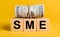 SME with money on a yellow background. The concept of business, finance, credit, income, savings, investments, exchange, tax