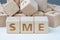 SME, small and medium-sized enterprises concept, cube wooden block with alphabet combine the word SME, entrepreneur business