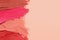 Smears of beautiful lipsticks on beige background, top view. Space for text