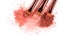 Smears of crushed pink blusher with brushes