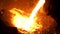 Smelting of the metal in the foundry at the steel mill. Stock footage. Close up for hot steel being poured from the