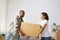 Smile african american Couple carry big cardboard box