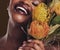 Smile, beauty and protea with the face of a black woman in studio on brown background for natural treatment. Skincare