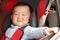 Smile boy in baby safe seat of car