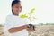 smile children holding young tree for planting