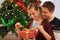 Smile, Christmas gift and couple in living room at home for festive celebration together. Happy, love and young man and