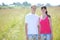 Smile couple hold hands in field
