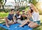 Smile everyone. Full length shot of a young group of friends taking selfies while enjoying a few drinks outside in the