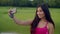 Smile girl taking selfie outdoors. Close up of sporty woman taking selfie photo