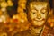 Smile of the golden Buddha, Face of gold buddha With bokeh background, Thailand, Asia,