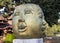 Smile golden face statue