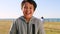 Smile, grass and portrait of child at beach having fun and playing in park. Nature, freedom and face of boy laughing