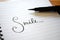 SMILE hand-lettered in notebook