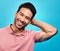 Smile, happy and portrait of Asian man on blue background with pride, confidence and happiness. Fashion, confident and