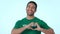 Smile, heart and a volunteer man pointing at you on a blue background in studio for love, charity or support. Portrait