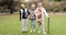 Smile, retirement and senior friends in the park, laughing together while standing on a field of grass. Portrait