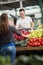 Smile salesman presentation vegetables on stall