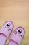 Smile slippers and happy, close up view, on wooden floor