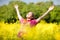 Smile teen open hands standing on yellow field