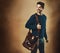 Smile, thinking and man with bag for fashion  on a brown background mockup space in studio. Idea, vision and