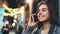 Smile woman calling mobile phone on background bokeh light in night europe city, happy girl  using smartphone technology. Digital