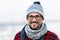 Smiled man in glasses. Portrait of smiling urban man in glasses and hat. Happy smiled guy in winter knitted hat and scarf.