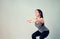 Smiley Asian woman wearing sportswear and practice yoga in living room. Healthy lifestyle concept.