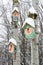 Smiley birdhouses. Birdhouse in the form of a funny face on the tree. Handmade wooden nesting box covered in snow. Winter landscap