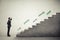 Smiley businessman in formal wear standing near concrete stairs