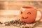 Smiley coffee mug on wood background