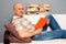 Smiley elderly man reading interesting book