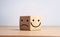 Smiley face on the bright side and a sad face on the dark side on the toy block cube for positive mindset selection.