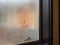 Smiley face drawn in condensation and foggy window in restaurant