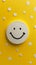 Smiley Face on Yellow Surface With White Dots