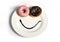 Smiley happy face made on dish with donuts eyes and chocolate syrup as smile in sugar and sweet addiction nutrition