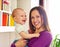 Smiley mother and adorable son at home