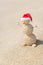 Smiley sandy snowman in santa hat. Holiday concept for New Years