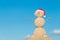 Smiley sandy snowman in santa hat. Holiday concept for New Years