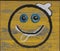 Smiley smiling face symbol smile spray on metal sheet wall graffiti photo