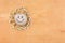 Smiley stone and daisies lying on a wooden surface.