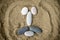 Smiley of stones on sand closeup