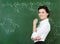 Smiley teacher standing at the blackboard